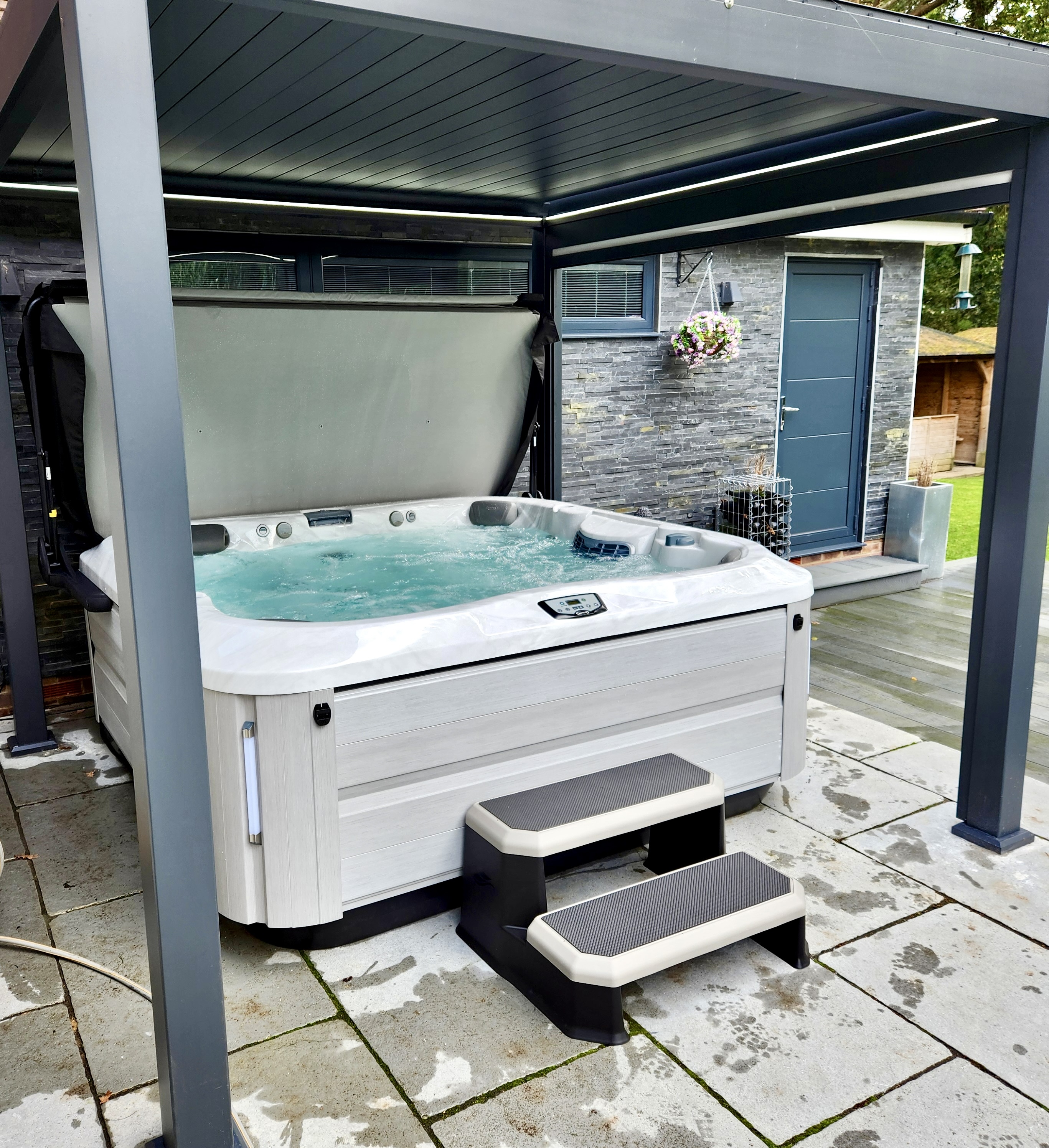 Hot tub maintained beneath a garden pergola
